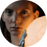 Portrait of a woman holding a mirror, showcasing beauty and skincare themes.