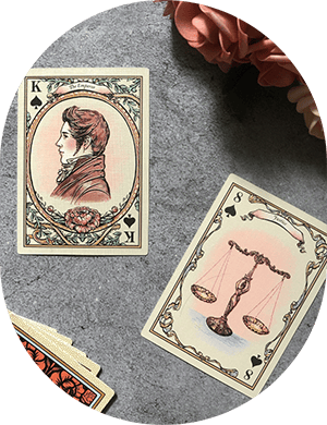 Elegant vintage playing cards featuring a woman's profile and justice scales, perfect for card games or collection.
