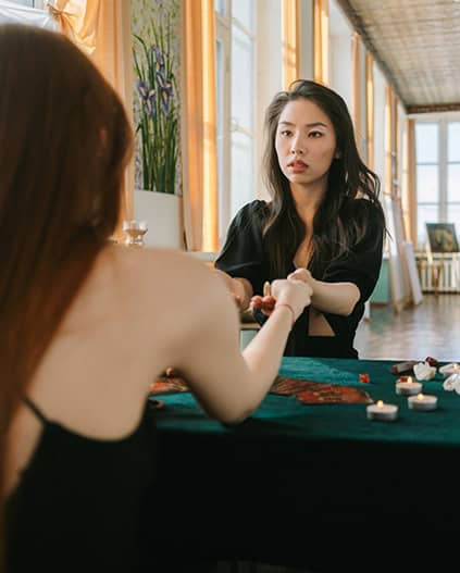 Elegant woman playing Mah-Jong at a cozy cafe, enjoying social games with friends in a warm, inviting atmosphere.